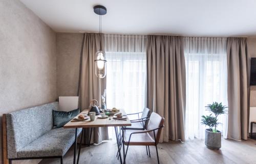 a living room with a table and a couch at Glanz & Glory Appartements Sölden in Sölden