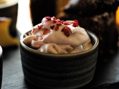 a bowl of ice cream with red sprinkles on it at Loch Melfort Hotel in Ardfern
