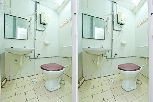 a bathroom with a toilet and a sink at Grand Heritage Hotel in Melaka
