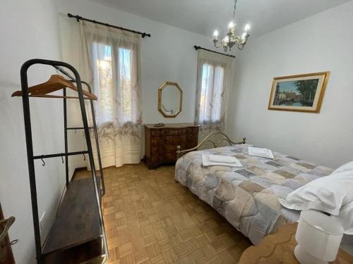 a bedroom with a bed and a mirror and a ladder at Casa Argia in Padova