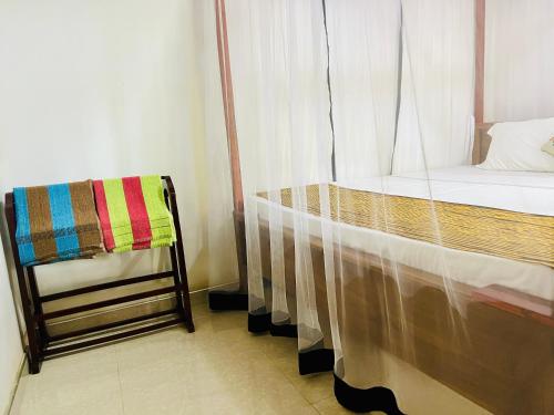 a bed and a chair in a room at Sun Beach in Tangalle