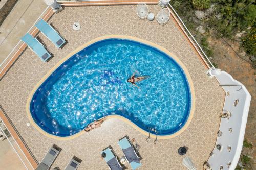 an overhead view of a large swimming pool at Seaview Villa Prima, Sea & Sun Villas in Chorafakia