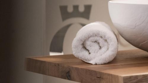 a doughnut sitting on a wooden shelf next to a cup at Glanz & Glory Appartements Sölden in Sölden