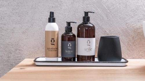 three bottles on a tray on a table at Glanz & Glory Appartements Sölden in Sölden