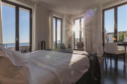 a bedroom with a bed with a view of the ocean at A-ROSA Hotel Ceres am Meer - Adults Only in Binz