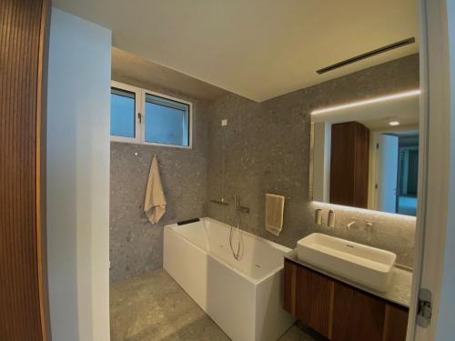 a bathroom with a sink and a large mirror at Infinity Villa Salò in Salò