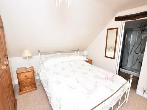 a bedroom with a bed and a dresser and a window at 1 Bed in Curbar PK455 in Curbar