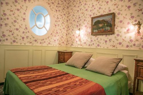 a bedroom with a bed and a round window at La Petite Calanque in Marseille