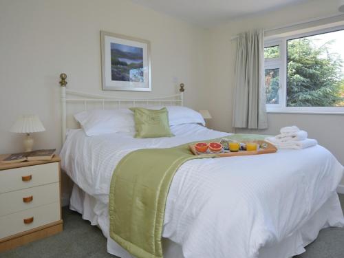 a bedroom with a bed with a tray of fruit on it at 4 Bed in Thirsk 49481 in Thirsk