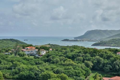 a house on top of a hill next to the ocean at Hilltop Villa with great views out to sea - Villa Cadasse villa in Cap Estate