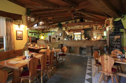 a restaurant with wooden tables and chairs and a bar at ALMI - penzion - pizzerie in Staré Splavy