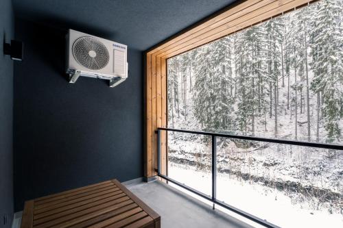 a room with a window with a fan next to a balcony at Mlýn Herlíkovice in Hořejší Vrchlabí