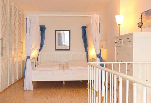 ein Schlafzimmer mit einem Himmelbett in der Unterkunft Apartmentvermittlung Mehr als Meer - Objekt 7 in Niendorf