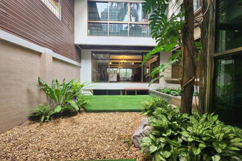 a house with a green lawn in front of it at Cordia Residence Saladaeng in Bangkok