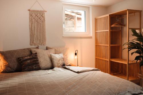 a bedroom with a bed and a window at Haus Meierhüsli in Malans