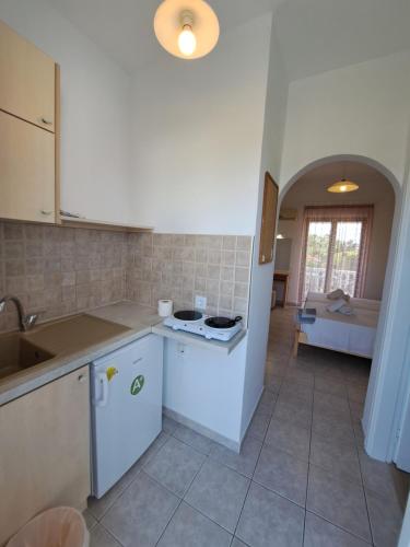 a kitchen with a sink and a stove at Studio Stars in Laganas