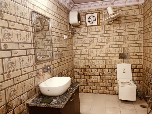 a bathroom with a sink and a toilet at Hotel Khandaka mahal in Jaipur