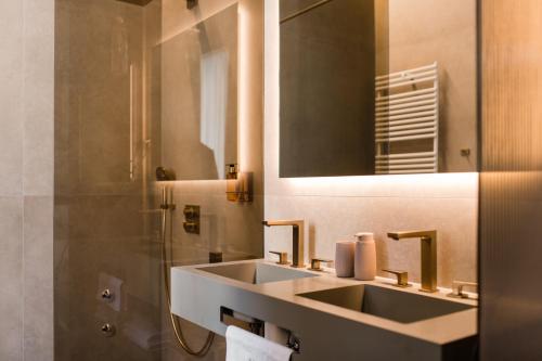 a bathroom with a sink and a mirror at Boutique Hotel HOH in Zagreb