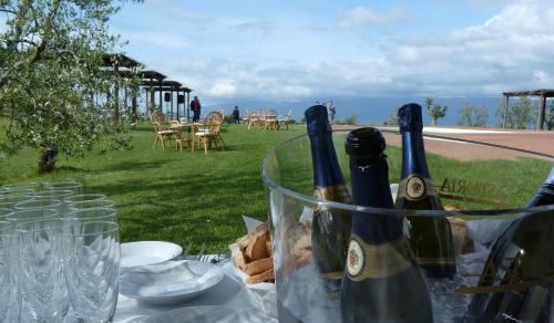 two bottles of wine sitting on a table with glasses at Agriturismo La Forra in Cavriglia