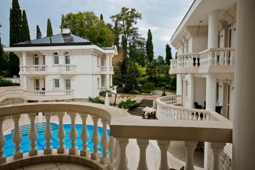 uma mansão branca com uma piscina e uma varanda em Villas & SPA by Ostrova em Sochi