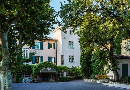 a large white building with trees in front of it at Le Pigonnet - Esprit de France in Aix-en-Provence