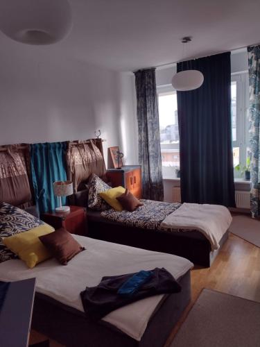 a hotel room with two beds and a window at ToTuToTam_02 in Warsaw
