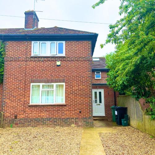 a brick house with a white door and a fence at Summertown Oxford- Entire 4 bedroom home, sleeps up to 10- 10 mins to city centre in Oxford