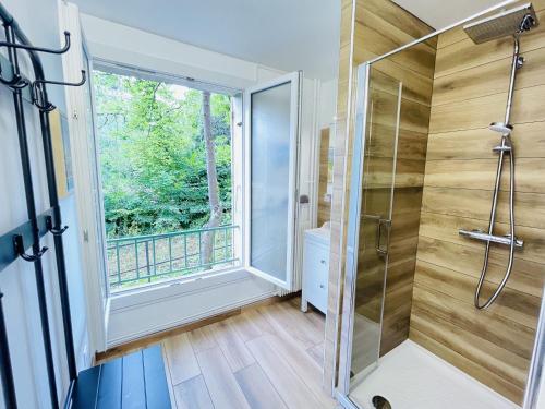 a bathroom with a shower and a window at L'appart de Gauche in Le Creusot