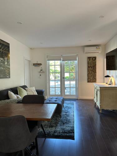 ein Wohnzimmer mit Sofa und Tisch in der Unterkunft Kookaburra Cottage in Bowral