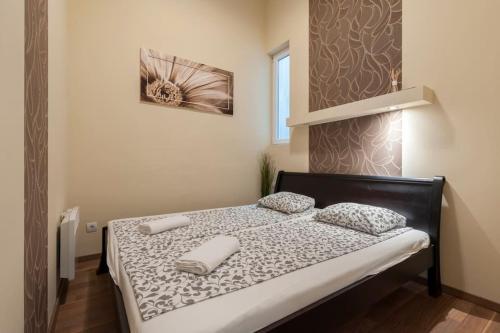 a bedroom with a bed with two pillows on it at Szent Istvan ter 4 Next to Basilica a 1 BedRoom in Budapest