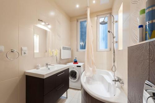 a bathroom with a sink and a washing machine at Szent Istvan ter 4 Next to Basilica a 1 BedRoom in Budapest