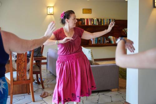 a woman in a pink dress standing in a living room at Aston Kaanapali Shores in Lahaina