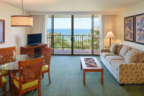 a living room with a couch and a table at Aston Kaanapali Shores in Lahaina