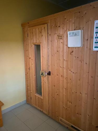 a wooden wall with a door in a room at La Gavina Loft Xàbia & ARCADE in Jávea