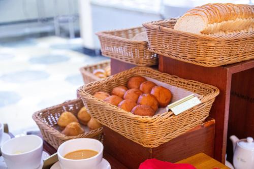 a group of baskets of donuts on a table at Tiffany Diamond Hotels Ltd - Indira Gandhi street in Dar es Salaam