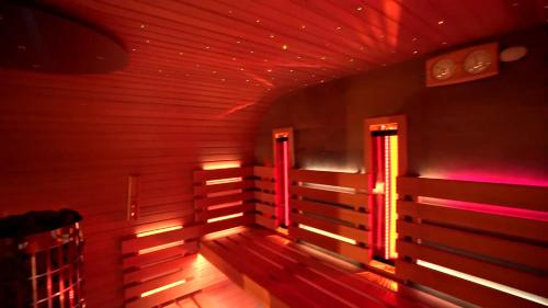 an empty room with red lights on the wall at Csonkás Kúria Vendégház Zemplén in Mogyoróska