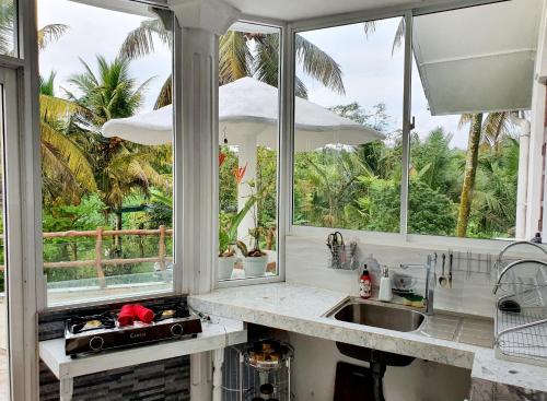 a kitchen with a sink and two windows at GreenHeart Villa- Top Floor, Specious 3BR-1BR AC - Hot W, Peace in Greenary & Fresh Air -Travel Awards 2025 in Maharagama