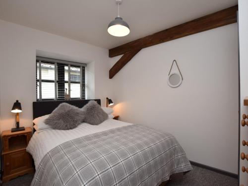 a bedroom with a bed with two pillows on it at 2 bed in Godshill IC085 in Godshill