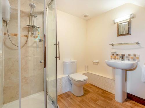 a bathroom with a shower and a toilet and a sink at 3 bed in Carisbrooke IC037 in Newport