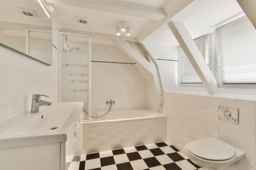a bathroom with a sink and a toilet and a bath tub at Amsterdam Alley Apartment in Amsterdam