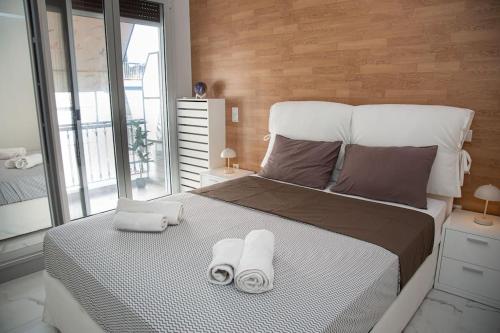 a bedroom with a large bed with towels on it at Spacious apartment in Pagkrati in Athens