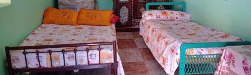 two beds sitting next to each other in a room at HaYaH Guest house in Aswan