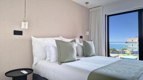 a bedroom with a bed with a view of the ocean at Roots Loft by LovelyStay in Funchal
