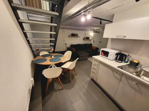 una piccola cucina e un tavolo con sedie in camera di Kant 99 XL a Berlino