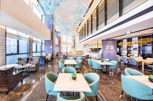 a restaurant with blue chairs and tables at Atour Hotel Furong Middle Road Changsha in Changsha