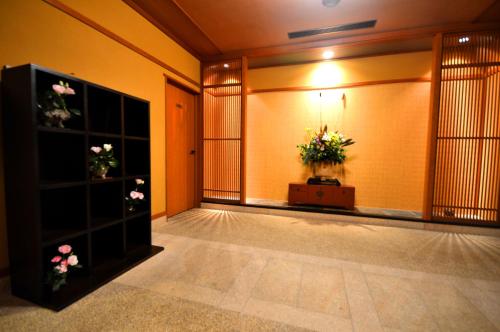 a lobby with a room with flowers on the wall at Futari Shizuka in Komagane