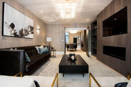a living room with a couch and a table at New, luxury 3 bed duplex in Covent Garden in London