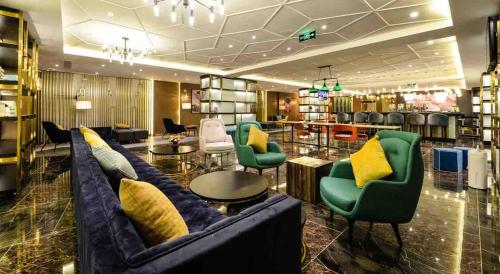 a lobby with couches and chairs in a store at Atour Hotel Zhoudun Beidaihe Qinhuangdao in Qinhuangdao