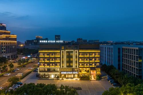 a hotel building with lights on in a city at Atour Hotel Yuyao Nanlei Building in Ningbo