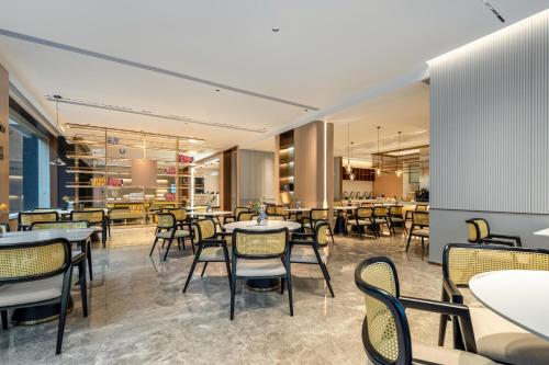 a restaurant with tables and chairs in a room at Atour Hotel Shanghai Hongqiao Xinzhuang Business District in Shanghai